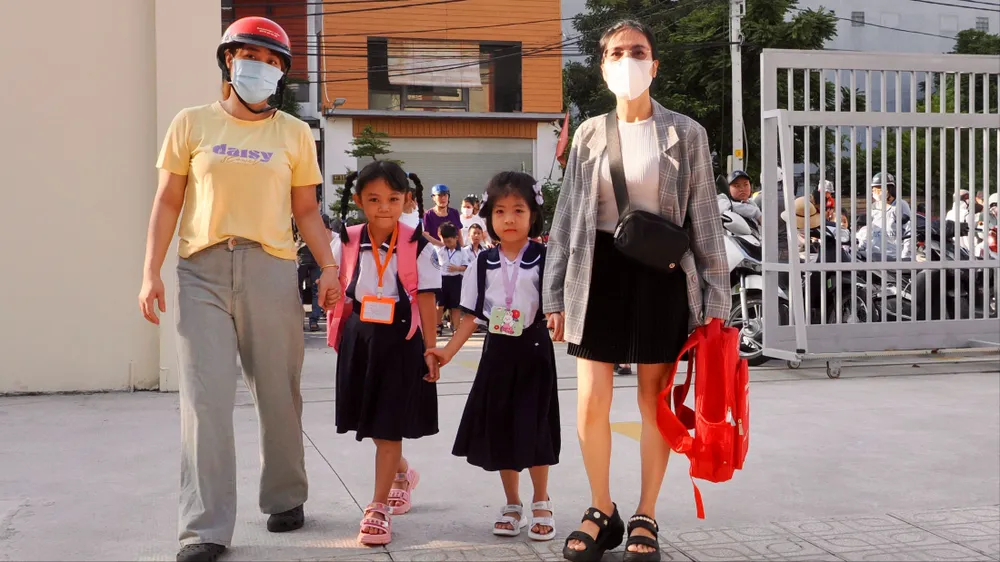 Phụ huynh đưa con đến Trường Tiểu học Đặng Thùy Trâm, phường An Hội Tây, TPHCM năm học mới 2025-2026. Ảnh: HOÀNG HÙNG