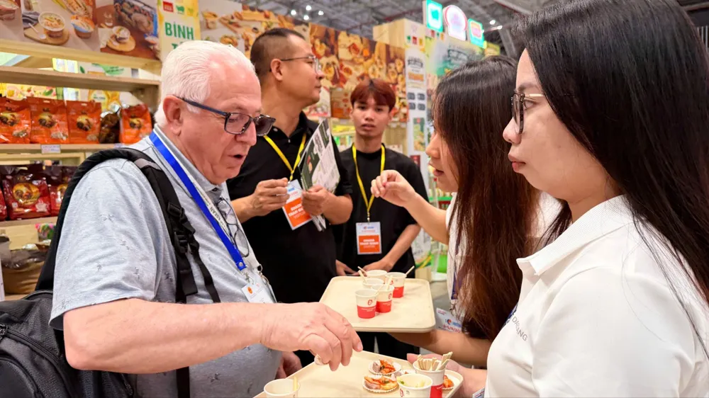 Đối tác quốc tế trực tiếp dùng thử, tìm hiểu sản phẩm thực phẩm Việt Nam tại triển lãm. Ảnh: HOÀNG HÙNG