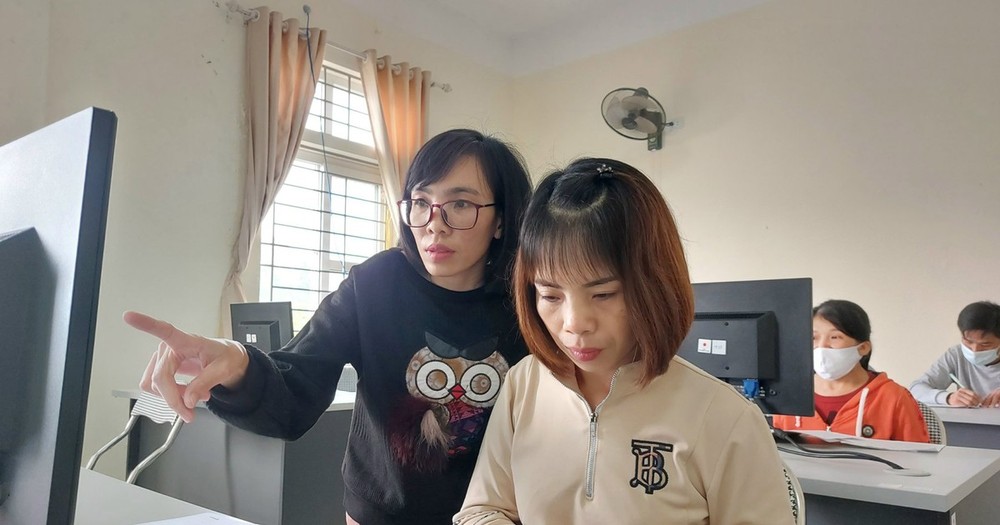 Ms. Quyen (standing) teaching Information Technology for AO victims. (Photo: SGGP)