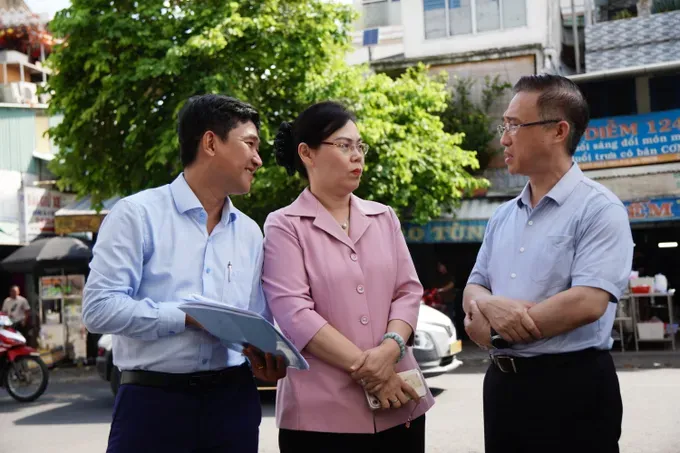 胡志明市市委副书记邓明通与平西坊领导商讨关于旧公寓改造、重建工作。图：清贤