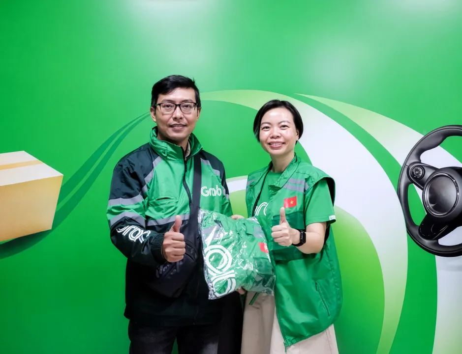 Bà Lý Thụy Bích Huyền, Giám đốc Vận hành, Grab Việt Nam, trao đồng phục tặng các bác tài Grab