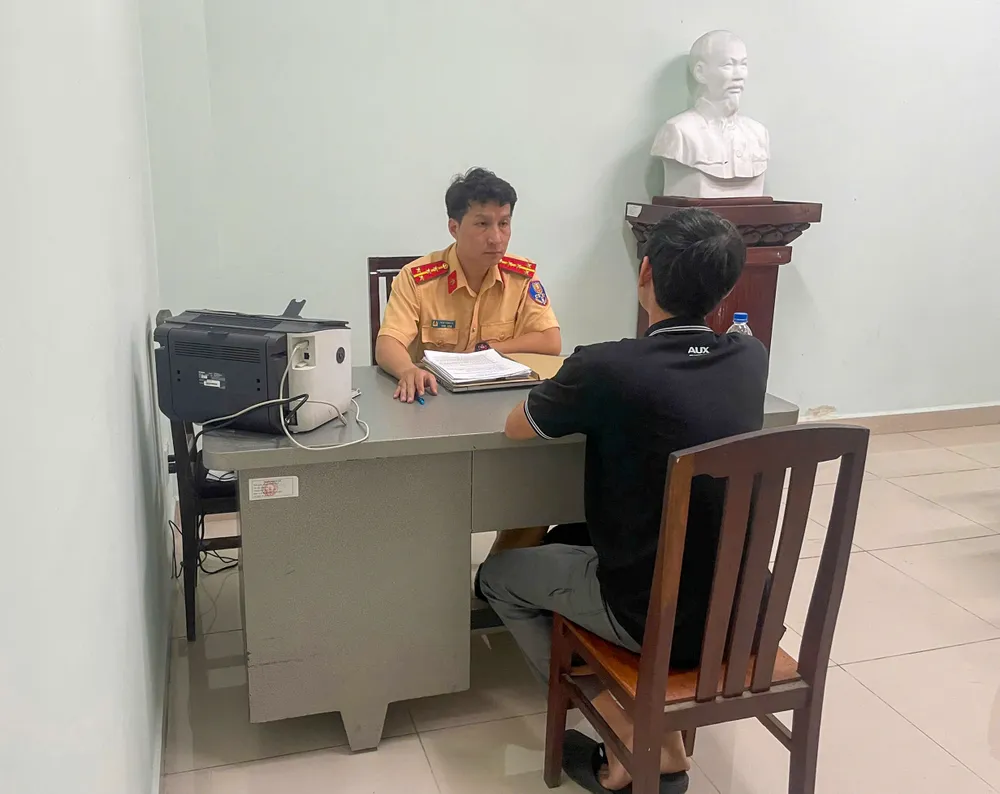 Cán bộ Phòng CSGT Công an TPHCM làm việc với ông D.T.Q.jpg