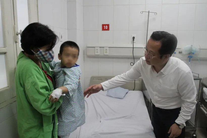 Giám đốc Sở GD-ĐT Hà Nội Trần Thế Cương hỏi thăm cháu bé con cô Đặng Thị Hải Yến, hiện đang điều trị cùng mẹ.