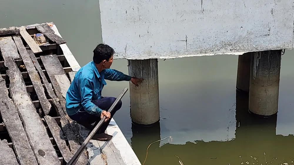 Người dân chỉ dấu vết dưới trụ cầu khi nước lên