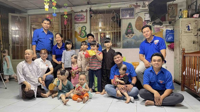 越南畜產技藝股份公司（Vissan）共青團書記陳青科（左站者）前往 第十二郡溫情屋探望不幸兒童。
