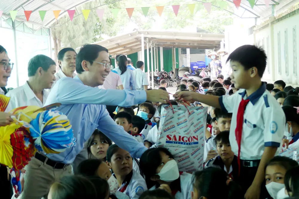 Phó Tổng Biên tập Báo SGGP Nguyễn Thành Lợi trao quà Trung thu cho học sinh. Ảnh: VIỆT NGA