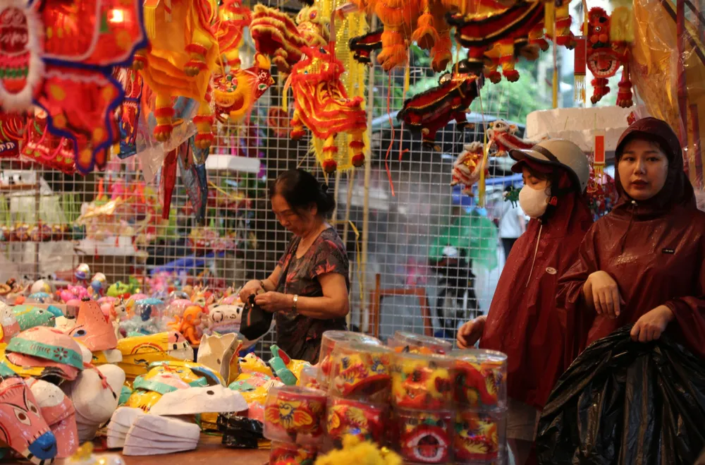 Thi thoảng mới có một vài người đội mưa tới mua nhanh một vài món đồ nhỏ. Ảnh: HÀ NGUYỄN