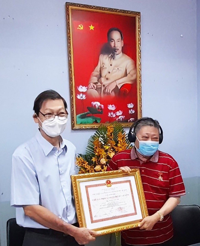 市商會副會長阮福興轉授“競賽戰士”稱號給杭慰瑤先生（右）。