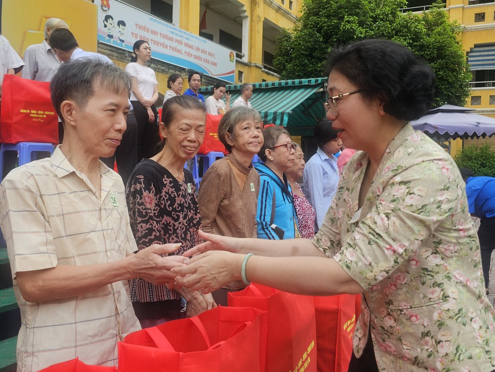 图：堤岸坊党部书记黄玉女芳红慰问华人同胞。
