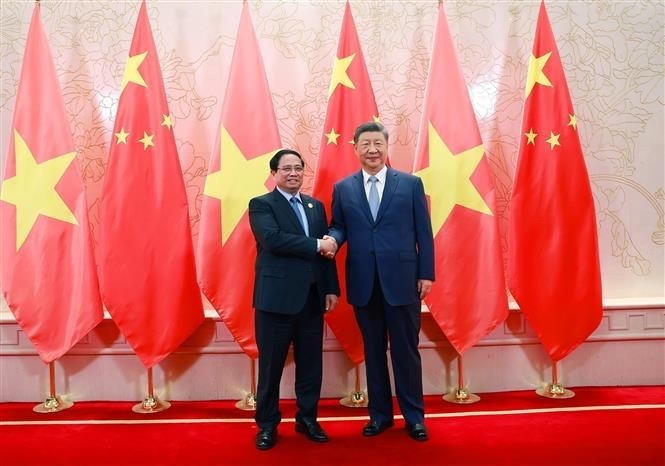 越南政府总理范明政会见中共中央总书记、国家主席习近平。图自越通社