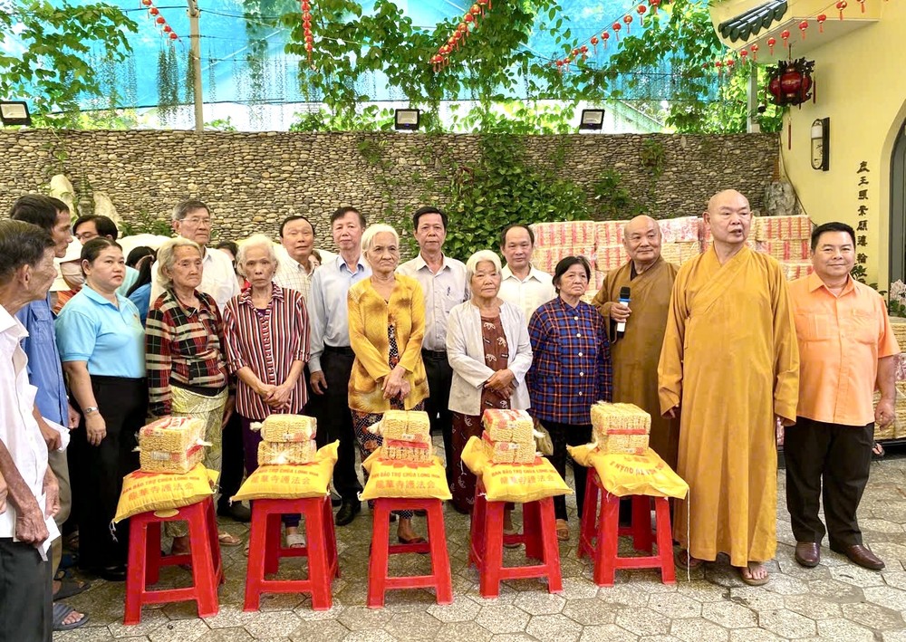 释慧功和尚和龙华寺护法会成员向贫困群众发送慈善礼物。