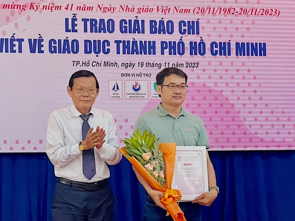 Ông Nguyễn Tấn Phong, Chủ tịch Hội Nhà báo TPHCM tặng hoa và Giấy chứng nhận đoạt giải Nhất cho nhóm phóng viên Quang Huy - Thu Tâm, Báo Sài Gòn Giải Phóng. Ảnh: AN KHÁNH