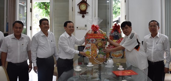 The delegation offers a Tet gift to former Deputy Chief of the Office of the Communist Party of Vietnam (CPV) Central Committee Nguyen Van Dang (2nd, R). (Photo: SGGP)