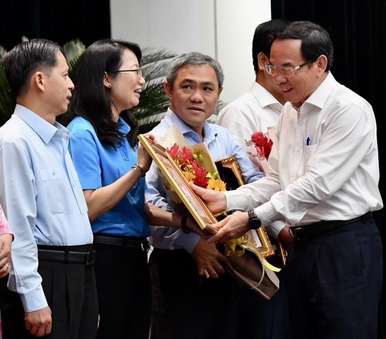 Secretary of the HCMC Party Committee Nguyen Van Nen offers certificates of merit to outstanding collectives and individuals. (Photo: SGGP)