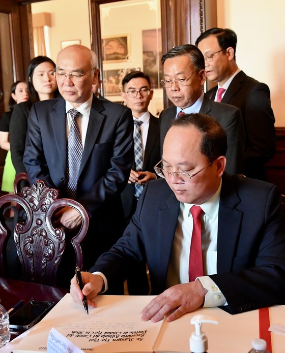 Vice Secretary of the HCMC Party Committee Nguyen Ho Hai writes in a scrapbook at the meeting. (Photo: SGGP)