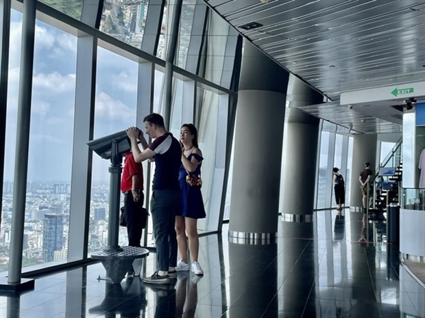 Foreign visitors enjoy the panoramic view of HCMC at the Saigon Skydeck. (Photo: VNA)