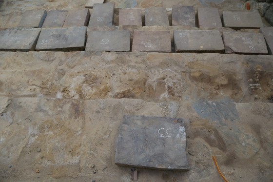 The stone paving slabs are numbered and re-laid in their original position.