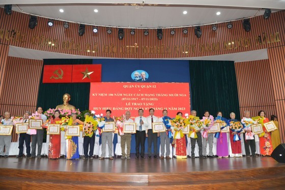 At a ceremony honoring Party members with Party membership badges in District 12