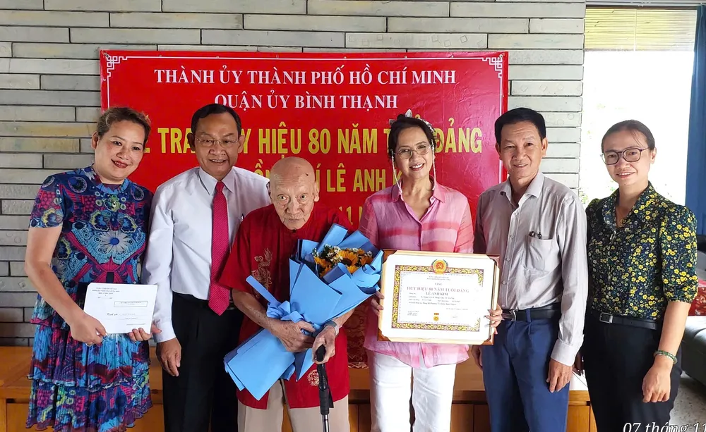 Thiếu tướng Đinh Thanh Nhàn, Phó Trưởng Ban Tổ chức Thành ủy TPHCM trao Huy hiệu 80 năm tuổi Đảng đến đồng chí Lê Anh Kim