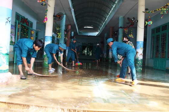 Người dân Quảng Ngãi dọn bùn đất sau mưa lũ ảnh 1