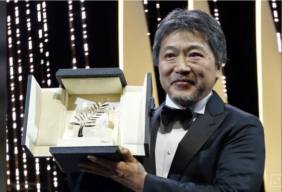 Đạo diễn Hirokazu Kore-eda và Cành cọ vàng danh giá. Ảnh: REUTERS