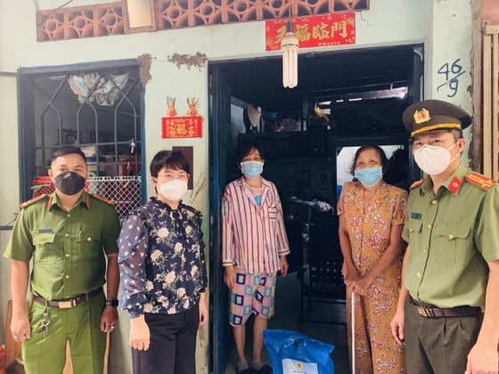 Thượng tá Nguyễn Hải Phước cùng lãnh đạo UBND quận 5 trao tận tay bà con người Hoa có hoàn cảnh khó khăn trên địa bàn quận 5. Ảnh: CHÍ THẠCH 