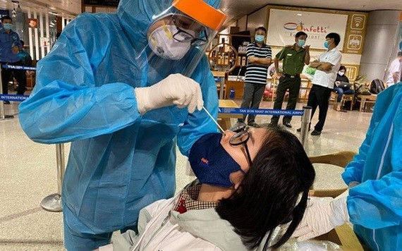 口岸防疫工作人員向一名入境者進行鼻拭子取樣測試。（圖源：VTV）