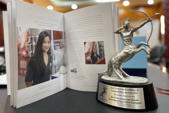 平仙日用品製作有限公司總經理尤麗娟與她榮獲的亞洲卓越企業獎座。