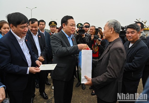 国会主席王廷惠（中）探望广平省渔民并赠送春节礼物。（图：人民报）