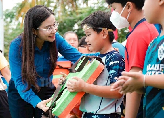 共青团中央书记阮范维庄向儿童赠送救生衣。（图：市党部新闻网）