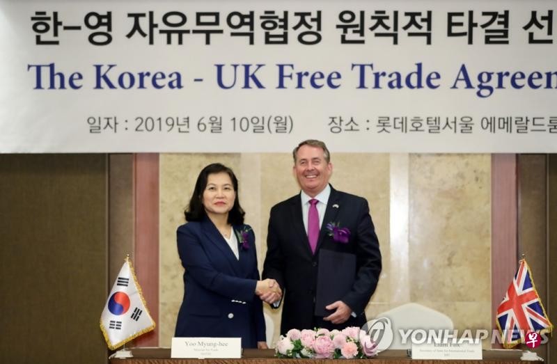  俞明希（左）和福克斯宣布韓英兩國自貿協定談判達成初步原則性協議。 （ 圖源：韓聯社）