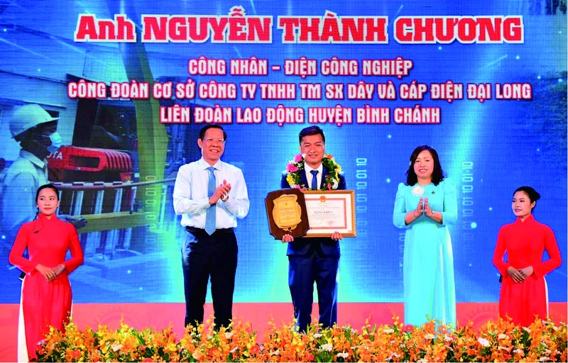 市委常務副書記、市人委會主席潘文邁向阮成章工人模範頒獎。