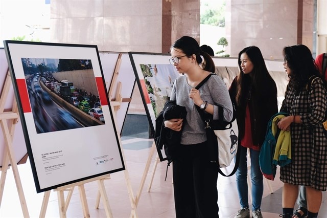 University students look at a photo exhibition on air pollution in Vietnam's big cities (Photo courtesy of CHANGE)