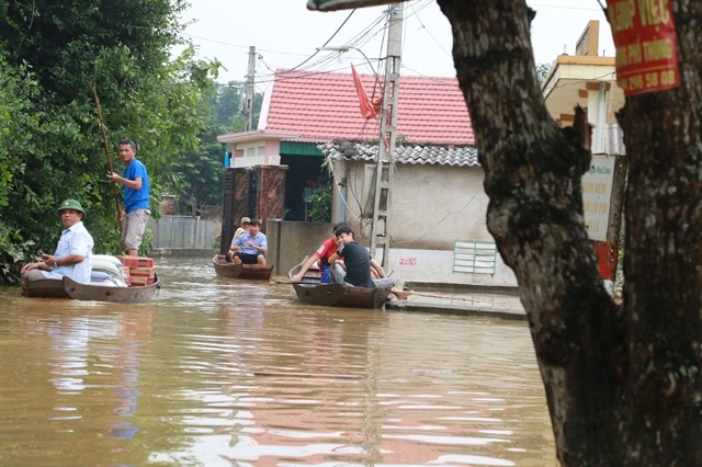 Residents in Trung Phuc Cuong Commune, Nam Dan District, the central province of Nghe An have to travel by boat due to floodwater that has remained until early November. — VNA/VNS Photo