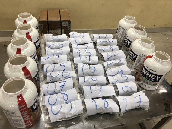 Suspected drugs are packaged and hidden inside nutrition supplement cans together with a number of candy shipment.