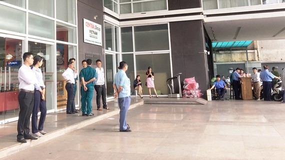 Representatives of some garment and textile firms wait for leaders of Central Group Vietnam at the group’s headquarters in HCMC on July 3 (Photo: SGGP)