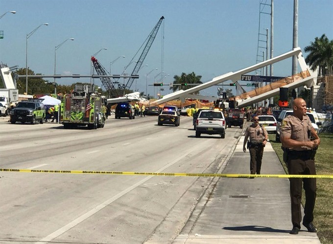 Police block a road near a newly installed pedestrian bridge that collapsed in Miami. – AFP/VNA Photo