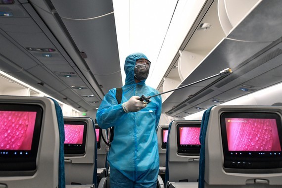 A worker cleaning and disinfecting an aircraft 